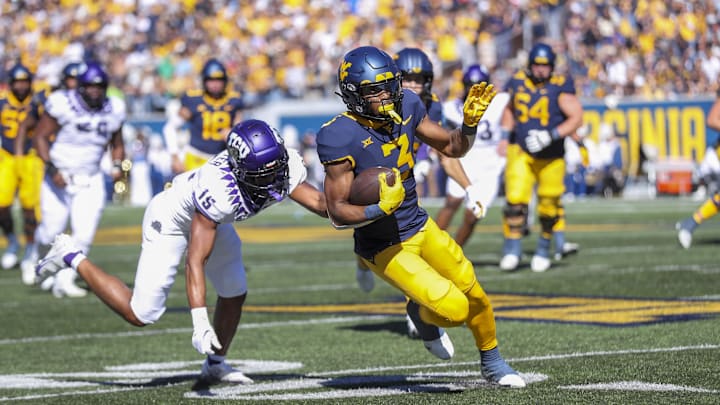 Oct 29, 2022; Morgantown, West Virginia, USA; West Virginia Mountaineers wide receiver Kaden Prather (3) catches a pass and runs past TCU Horned Frogs safety Josh Foster (15) during the second quarter at Mountaineer Field at Milan Puskar Stadium. Mandatory Credit: Ben Queen-Imagn Images