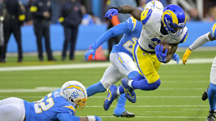 Jan 1, 2023; Inglewood, California, USA; Los Angeles Rams running back Cam Akers (3) breaks away from Los Angeles Chargers linebacker Khalil Mack (52) for a first down in the second half at SoFi Stadium. Mandatory Credit: Jayne Kamin-Oncea-Imagn Images