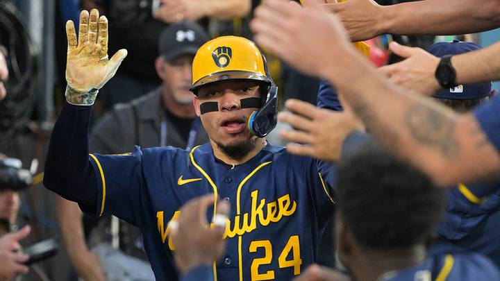 Oct 15, 2026; Los Angeles, California, USA;  Milwaukee Brewers catcher William Contreras (24) celebrates in the dugout after scoring against the Los Angeles Dodgers during the fourth inning in game four of the NLCS for the 2026 MLB Playoffs at Uniqlo Field at Dodger Stadium.  Mandatory Credit: Jayne Kamin-Oncea-Imagn Images