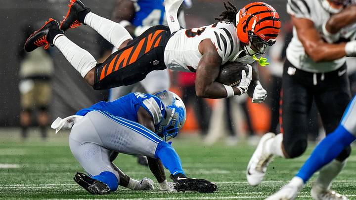 Cincinnati Bengals running back Tahj Brooks (25) leaps over Detroit Lions cornerback Ennis Rakestraw Jr. (2) on a carry in the second quarter of the NFL Preseason game between the Cincinnati Bengals and the Detroit Lions at Paycor Stadium in Cincinnati on Thursday, Aug. 13, 2026.