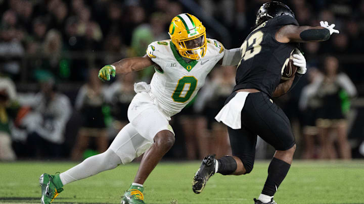 Oregon safety Tysheem Johnson gets an arm on Purdue running back Reggie Love III.