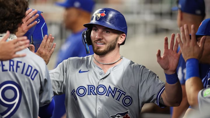 Former Toronto Blue Jays first baseman Horwitz celebrates with teammates after scoring a run.