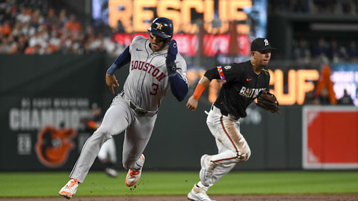Aug 23, 2024; Baltimore, Maryland, USA;  Houston Astros shortstop Jeremy Pena (3) rounds third base as Baltimore Orioles third baseman Ramon Urias (29) breaks on a infield hit at Oriole Park at Camden Yards. Mandatory Credit: Tommy Gilligan-Imagn Images