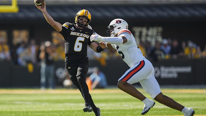 Oct 19, 2024; Columbia, Missouri, USA; Missouri Tigers quarterback Drew Pyne (6) throws a pass against Auburn Tigers defensive lineman Keldric Faulk (15) during the first half at Faurot Field at Memorial Stadium. Mandatory Credit: Jay Biggerstaff-Imagn Images