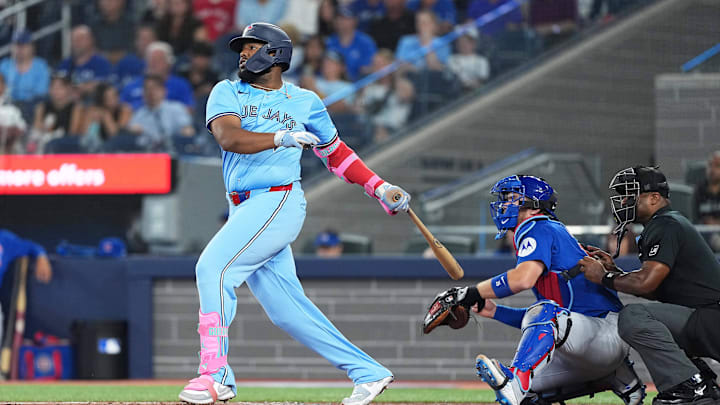 Aug 12, 2025; Toronto, Ontario, CAN; Toronto Blue Jays first baseman Vladimir Guerrero Jr. (27) hits a single against the Chicago Cubs during the first inning at Rogers Centre. 
