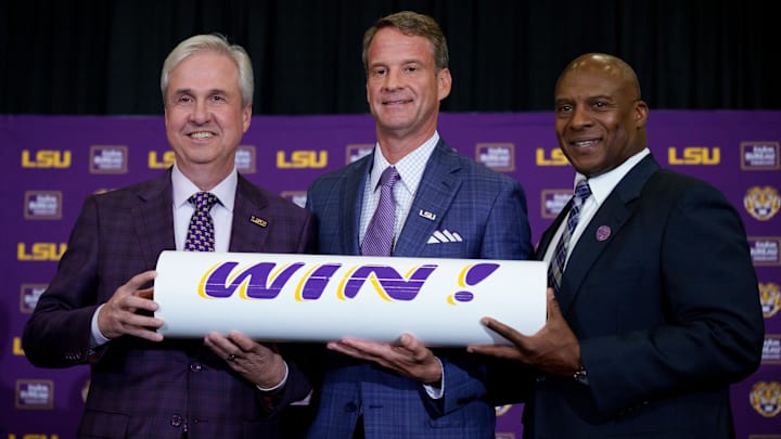 LSU president Wade Rousse, left, head coach Lane Kiffin and athletic director Verge Ausberry stand together