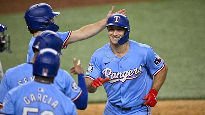 Sep 22, 2024; Arlington, Texas, USA; Texas Rangers left fielder Wyatt Langford (36) celebrates with shortstop Josh Smith (8) and second baseman Marcus Semien (2) and right fielder Adolis Garcia (53) after Langford hits a three run home run against the Seattle Mariners during the sixth inning at Globe Life Field. Mandatory Credit: Jerome Miron-Imagn Images
