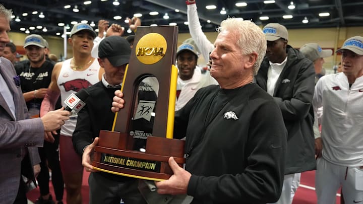 Arkansas Razorbacks coach Chris Bucknam holds the team championship trophy during the NCAA Indoor Championships at Albuquerque Convention Center.
