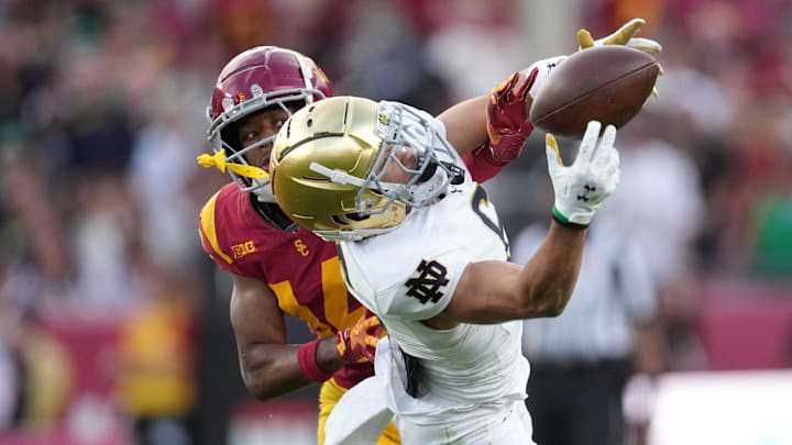 Nov 30, 2024; Los Angeles, California, USA; Notre Dame Fighting Irish wide receiver Jordan Faison (6) attempts to catch the ball against Southern California Trojans cornerback Jacobe Covington (14) in the second half at United Airlines Field at Los Angeles Memorial Coliseum. Mandatory Credit: Kirby Lee-Imagn Images Nov 30, 2024; Los Angeles, California, USA; Notre Dame Fighting Irish wide receiver Jordan Faison (6) attempts to catch the ball against Southern California Trojans cornerback Jacobe Covington (14) in the second half at United Airlines Field at Los Angeles Memorial Coliseum. Mandatory Credit: Kirby Lee-Imagn Images