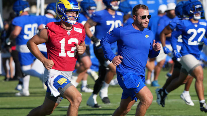 Jul 23, 2025; Los Angeles, CA, USA; Los Angeles Rams coach Sean McVay runs with quarterback Stetson Bennett (13) during training camp at Loyola Marymount University. Mandatory Credit: Kirby Lee-Imagn Images
