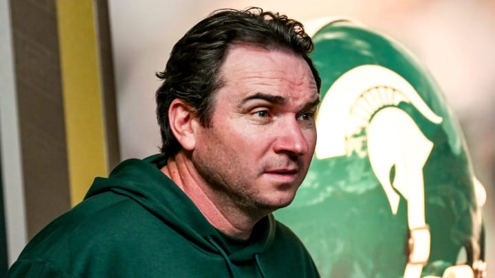 Michigan State coach Jonathan Smith takes the podium before talking to the media on the first