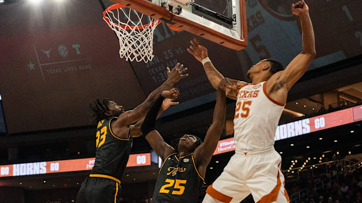 Texas Longhorns forward Jayson Kent (25), Missouri Tigers guard Aidan Shaw (23) and Missouri Tigers guard Mark Mitchell (25) reach for the ball as the Longhorns take on Mizzou at the Moody Center on Jan. 21, 2025.