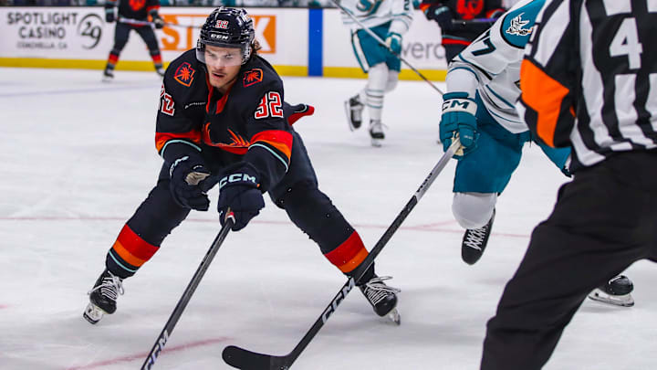 Coachella Valley forward Tucker Robertson (32) works to keep the puck away from San Jose defenseman Valtteri Pulli (77) during the first period of their game at Acrisure Arena in Palm Desert, Calif., Thursday, April 4, 2024.