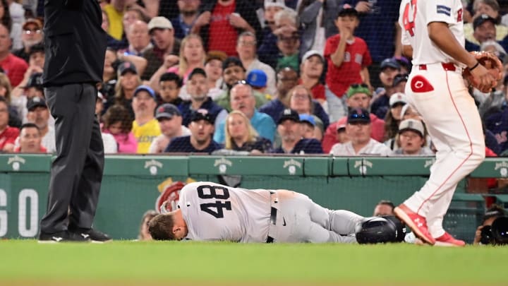 Jun 16, 2024; Boston, Massachusetts, USA; New York Yankees first baseman Anthony Rizzo (48) trips on Boston Red Sox pitcher Brennan Bernardino (not pictured) and rolls on the ground during the seventh inning at Fenway Park. Mandatory Credit: Eric Canha-USA TODAY Sports Jun 16, 2024; Boston, Massachusetts, USA; New York Yankees first baseman Anthony Rizzo (48) trips on Boston Red Sox pitcher Brennan Bernardino (not pictured) and rolls on the ground during the seventh inning at Fenway Park. Mandatory Credit: Eric Canha-USA TODAY Sports