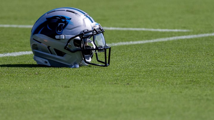 Jul 23, 2025; Charlotte, NC, USA; A Carolina Panthers helmet sits on the ground at training camp. Mandatory Credit: Scott Kinser-Imagn Images