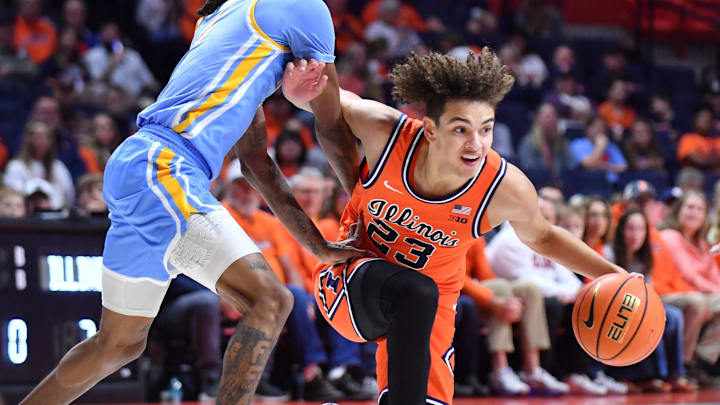 Nov 22, 2025; Champaign, Illinois, USA; Long Island University Sharks guard Malachi Davis (0) guards Illinois Fighting Illini guard Keaton Wagler (23) during the first half at State Farm Center. Mandatory Credit: Ron Johnson-Imagn Images
