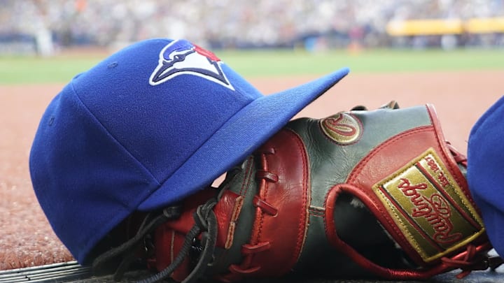 Jul 26, 2024; Toronto, Ontario, CAN; A Toronto Blue Jays hat and glove outside of the dugout during a game against the Texas Rangers at Rogers Centre. Mandatory Credit: John E. Sokolowski-Imagn Images