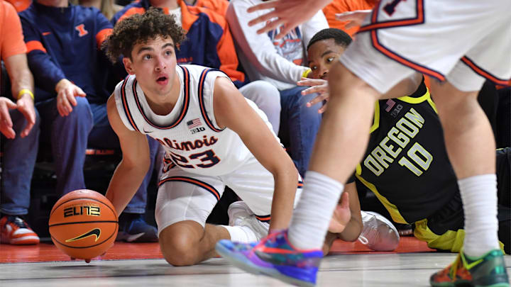 Mar 3, 2026; Champaign, Illinois, USA;  Illinois Fighting Illini guard Keaton Wagler (23) grabs a loose ball away from Oregon Ducks forward Kwame Evans Jr. (10).