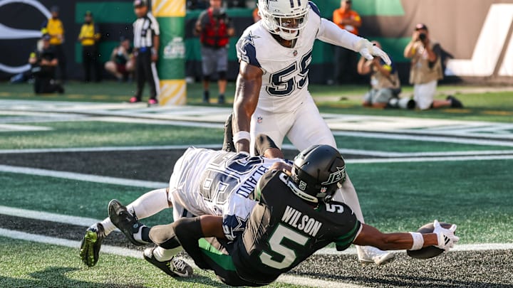 Oct 5, 2025; East Rutherford, New Jersey, USA; New York Jets wide receiver Garrett Wilson (5) scores a touchdown as Dallas Cowboys cornerback Daron Bland (26) defends during the second half at MetLife Stadium. Oct 5, 2025; East Rutherford, New Jersey, USA; New York Jets wide receiver Garrett Wilson (5) scores a touchdown as Dallas Cowboys cornerback Daron Bland (26) defends during the second half at MetLife Stadium.