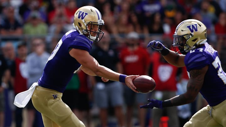 Aug 31, 2019; Seattle, WA, USA; Washington Huskies quarterback Jacob Eason (10) hands off to running back Kamari Pleasant (24)  during the second half against the Eastern Washington Eagles at Husky Stadium. Mandatory Credit: Jennifer Buchanan-USA TODAY Sports