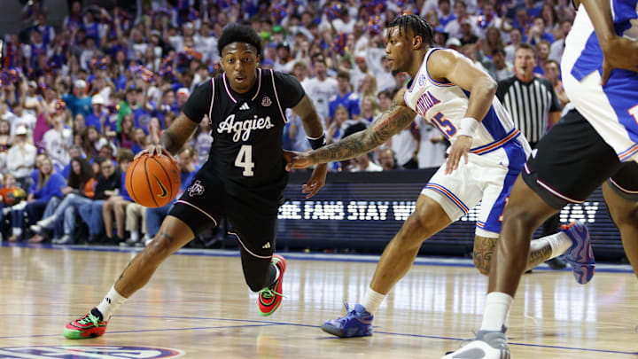 Mar 1, 2025; Gainesville, Florida, USA; Texas A&M Aggies guard Wade Taylor IV (4) dribbles the ball around Florida Gators guard Alijah Martin (15) during the first half at Exactech Arena at the Stephen C. O'Connell Center. Mandatory Credit: Morgan Tencza-Imagn Images