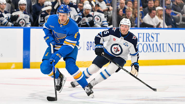Apr 9, 2026; St. Louis, Missouri, USA; St. Louis Blues defenseman Philip Broberg (6) controls the puck as Winnipeg Jets left wing Cole Koepke (45) defends during the second period at Enterprise Center. Mandatory Credit: Jeff Curry-Imagn Images