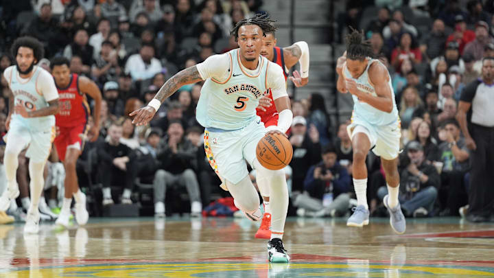 Dec 8, 2024; San Antonio, Texas, USA;  San Antonio Spurs guard Stephon Castle (5) dribbles in the second half against the New Orleans Pelicans at Frost Bank Center. Mandatory Credit: Daniel Dunn-Imagn Images