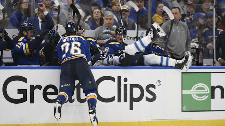 Apr 27, 2025; St. Louis, Missouri, USA; St. Louis Blues right wing Zack Bolduc (76) finishes a check on Winnipeg Jets center Mason Appleton (22) during the third period in game four of the first round of the 2025 Stanley Cup Playoffs at Enterprise Center. Mandatory Credit: Jeff Le-Imagn Images
