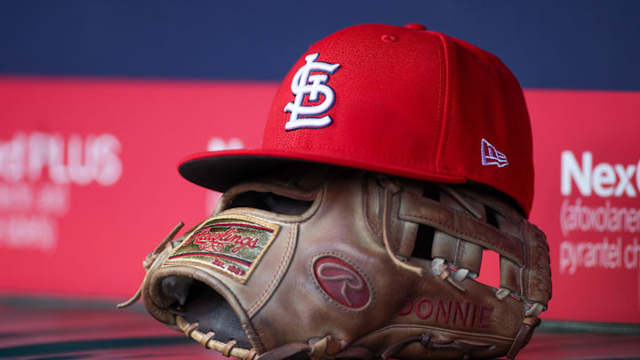 Apr 21, 2025; Atlanta, Georgia, USA; A St. Louis Cardinals hat and glove in the dugout against the Atlanta Braves in the first inning at Truist Park. Mandatory Credit: Brett Davis-Imagn Images