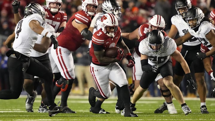 Nov 16, 2024; Madison, Wisconsin, USA;  Wisconsin Badgers running back Tawee Walker (3) rushes with the football during the third quarter against the Oregon Ducks at Camp Randall Stadium. 