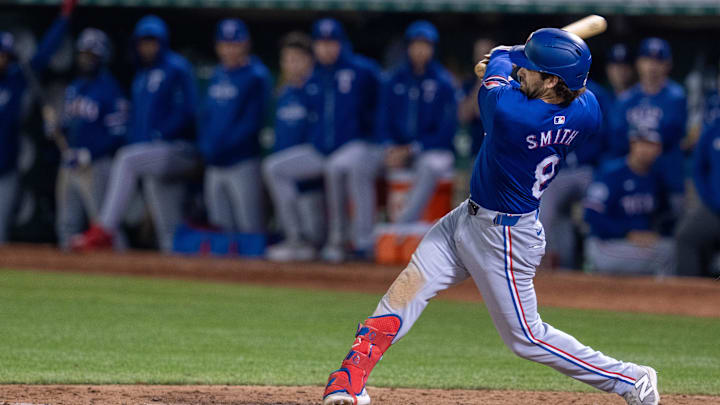 Sep 24, 2024; Oakland, California, USA; Texas Rangers shortstop Josh Smith (8) singles against the Oakland Athletics during the ninth inning at Oakland-Alameda County Coliseum. Mandatory Credit: Neville E. Guard-Imagn Images