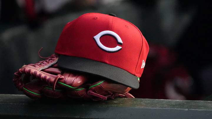 May 5, 2026; Chicago, Illinois, USA; A detail shot of Cincinnati Reds hat and glove in the dugout during the fourth inning against the Chicago Cubs at Wrigley Field. Mandatory Credit: David Banks-Imagn Images May 5, 2026; Chicago, Illinois, USA; A detail shot of Cincinnati Reds hat and glove in the dugout during the fourth inning against the Chicago Cubs at Wrigley Field. Mandatory Credit: David Banks-Imagn Images