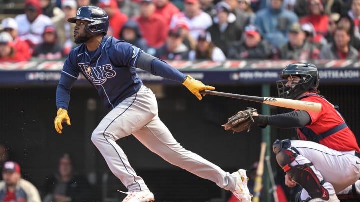 Oct 8, 2022; Cleveland, Ohio, USA; Tampa Bay Rays left fielder Randy Arozarena (56) hits an infield single against the Cleveland Guardians in the sixth inning during game two of the Wild Card series for the 2022 MLB Playoffs at Progressive Field. Mandatory Credit: Ken Blaze-USA TODAY Sports