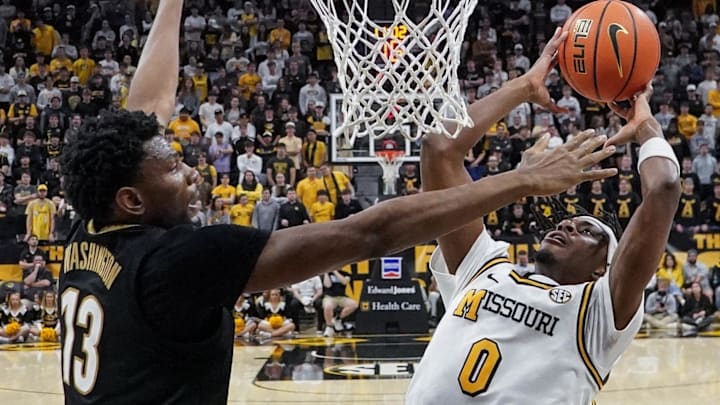 Feb 18, 2026; Columbia, Missouri, USA; Missouri Tigers guard Anthony Robinson II (0) shoots as Vanderbilt Commodores forward Jalen Washington (13) defends during the second half of the game at Mizzou Arena. Mandatory Credit: Denny Medley-Imagn Images