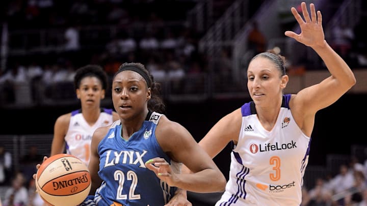 Sep 29, 2013; Phoenix, AZ, USA; Minnesota Lynx guard Monica Wright (22) drives the ball against the Phoenix Mercury guard Diana Taurasi (3) at US Airways Center.  The Lynx defeated the Mercury 72-65. Mandatory Credit: Jennifer Stewart-Imagn Images