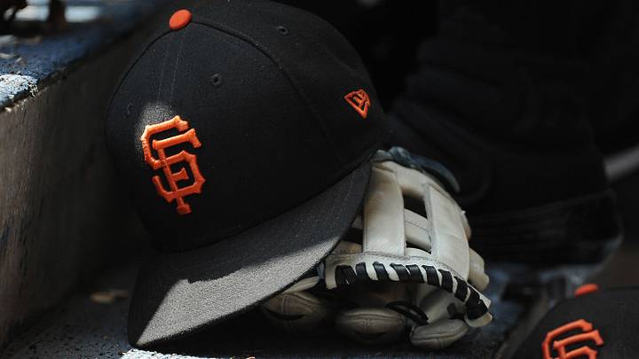 San Francisco Giants hat and glove in the dugout.