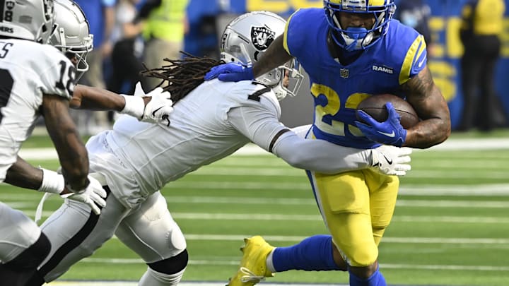 Oct 20, 2024; Inglewood, California, USA; Los Angeles Rams running back Kyren Williams (23) tries to break a tackle by Las Vegas Raiders safety Tre'von Moehrig (7) during the third quarter at SoFi Stadium. Mandatory Credit: Robert Hanashiro-Imagn Images