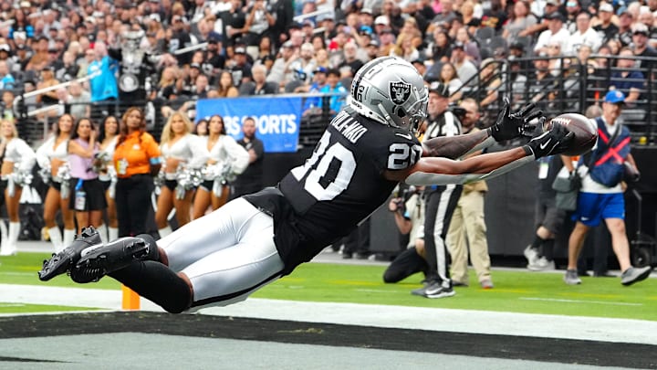 Sep 22, 2024; Paradise, Nevada, USA; Las Vegas Raiders safety Isaiah Pola-Mao (20) attempts to intercept a pass made by Carolina Panthers quarterback Andy Dalton (14) during the fourth quarter at Allegiant Stadium. Mandatory Credit: Stephen R. Sylvanie-Imagn Images
