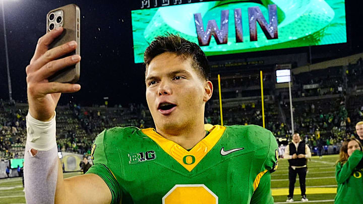 Oregon quarterback Dillon Gabriel posts a video on social media on his way off the field after defeating Maryland at Autzen Stadium Saturday, Nov. 9, 2024.