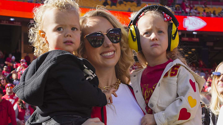 Brittany Mahomes and children watch warmups prior to game between the Kansas City Chiefs and the Denver Broncos at GEHA Field at Arrowhead Stadium.