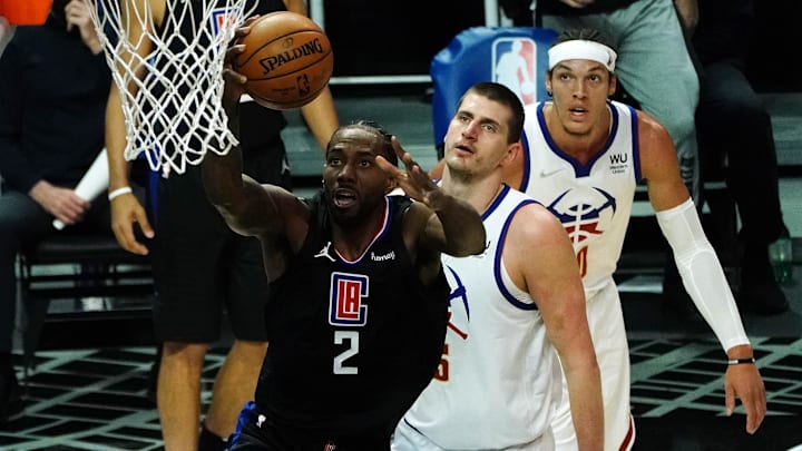 Los Angeles Clippers forward Kawhi Leonard (2) moves in for a basket ahead of Denver Nuggets center Nikola Jokic (15) and forward Aaron Gordon (50) during the first half at Staples Center. Mandatory Credit: Gary A. Vasquez-Imagn Images