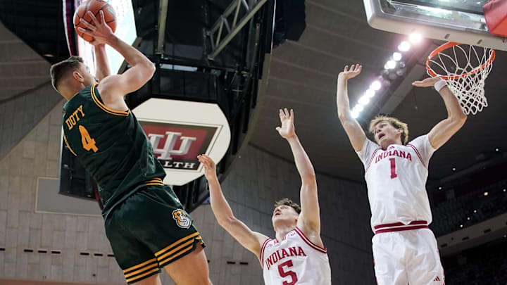 Siena guard Gavin Doty shoots over Indiana guard Conor Enright and forward Reed Bailey on Dec. 22, 2025, at Simon Skjodt Assembly Hall.