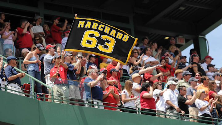 June 19, 2011; Boston, MA, USA; A Boston Red Sox employee waves a Brad Marchand (not pictured) flag as part of a pre-game ceremony to honor the 2011 Stanley Cup Champion Boston Bruins at Fenway Park. Mandatory Credit: Bob DeChiara-Imagn Images