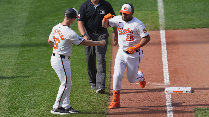 Sep 19, 2024; Baltimore, Maryland, USA; Baltimore Orioles designated hitter Anthony Santander (25) greeted by third base coach Tony Mansolino (36) following his game winning two run home run in the ninth inning against the San Francisco Giants at Oriole Park at Camden Yards. Mandatory Credit: Mitch Stringer-Imagn Images