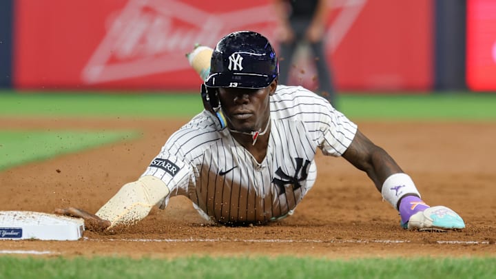 Aug 12, 2025; Bronx, New York, USA; New York Yankees second baseman Jazz Chisholm Jr. (13) slides safely back to first base during the fifth inning against the Minnesota Twins  at Yankee Stadium. Mandatory Credit: Vincent Carchietta-Imagn Images