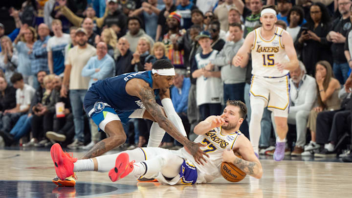 Los Angeles Lakers guard Luka Doncic (77) calls a timeout after stumbling on the defense of Minnesota Timberwolves forward Jaden McDaniels in the fourth quarter during Game 4 of their first-round playoff series at Target Center in Minneapolis on April 27, 2025.