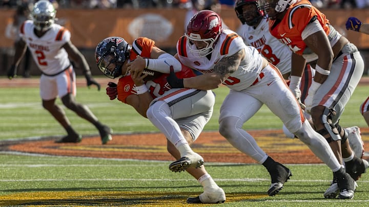 Feb 1, 2025; Mobile, AL, USA; National team defensive lineman Landon Jackson of Arkansas (40) hits American team quarterback Jaxson Dart of Ole Miss (2) during the first half of the 2025 Senior Bowl football game at Hancock Whitney Stadium.