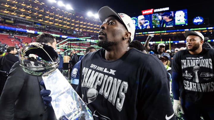 Feb 8, 2026; Santa Clara, CA, USA; Seattle Seahawks defensive end DeMarcus Lawrence (0) celebrates with the Vince Lombardi Trophy after defeating the New England Patriots during Super Bowl LX at Levi's Stadium. Mandatory Credit: Mark J. Rebilas-Imagn Images