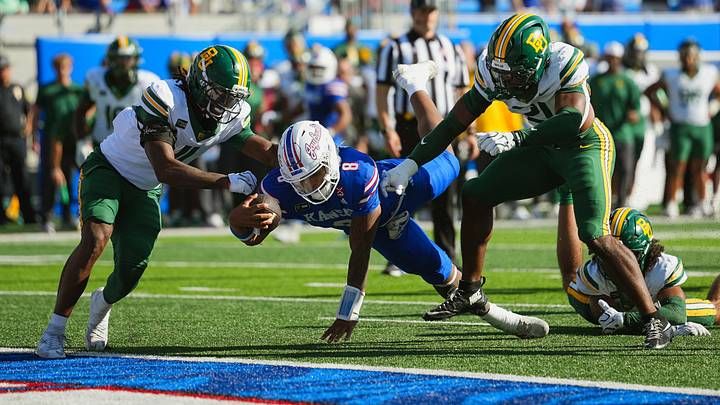 Oct 24, 2026; Lawrence, Kansas, USA; Kansas Jayhawks quarterback Isaiah Marshall (8) dives for a touchdown against Baylor Bears safety Devin Turner (11) and safety Bo Onu (21) during the second half at David Booth Kansas Memorial Stadium. Mandatory Credit: Jay Biggerstaff-Imagn Images