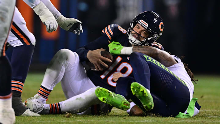 Dec 26, 2024; Chicago, Illinois, USA; Chicago Bears quarterback Caleb Williams (18) is sacked by Seattle Seahawks defensive back Rayshawn Jenkins (2) during the fourth quarter at Soldier Field. Mandatory Credit: Daniel Bartel-Imagn Images